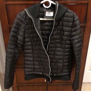Black nylon poly jacket with pockets, hoodie and ties to make smaller. Size S/M